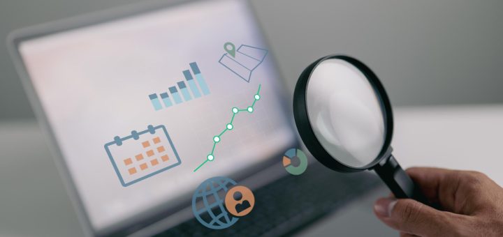 smart-business-analyst-with-magnifying-glass-scrutinizing-graphs-charts-financial-reports-investment-data-sales-information